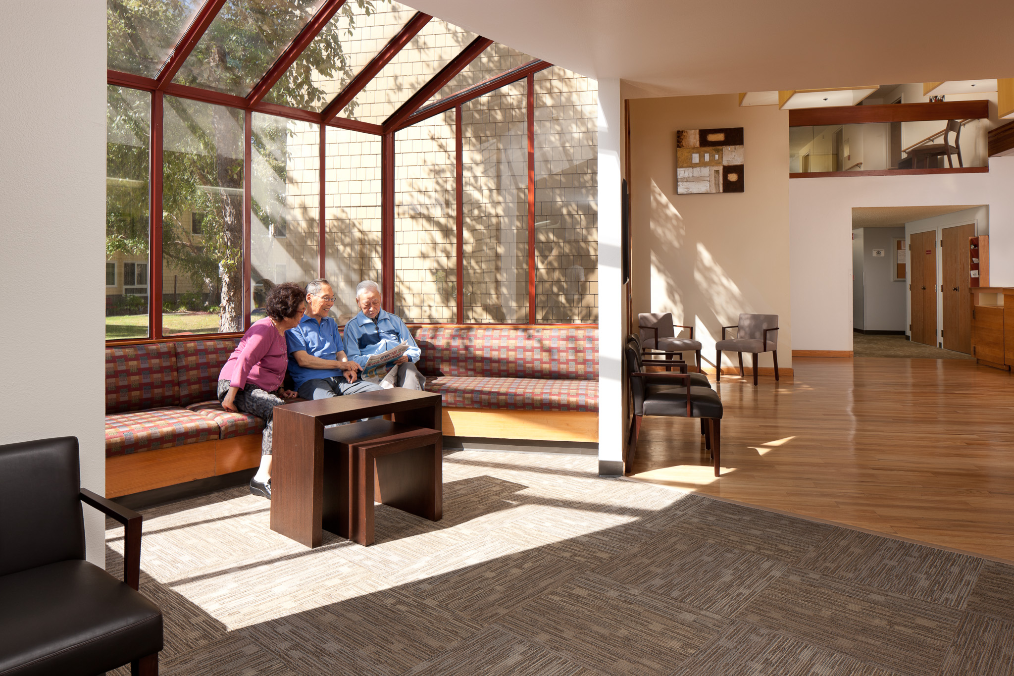 Residents gather in the lobby of Newark Gardens in Newark, CA.