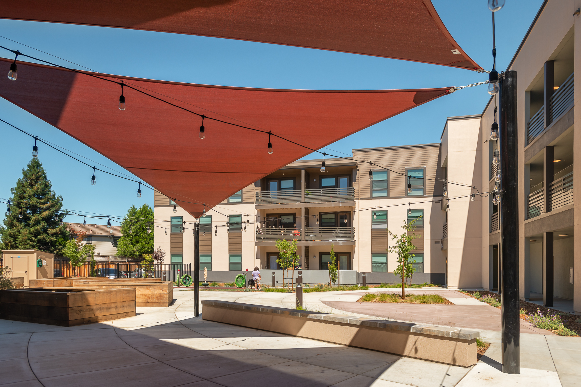 Sun shades cover the outdoor space at Manzanita Family Apartments in Napa