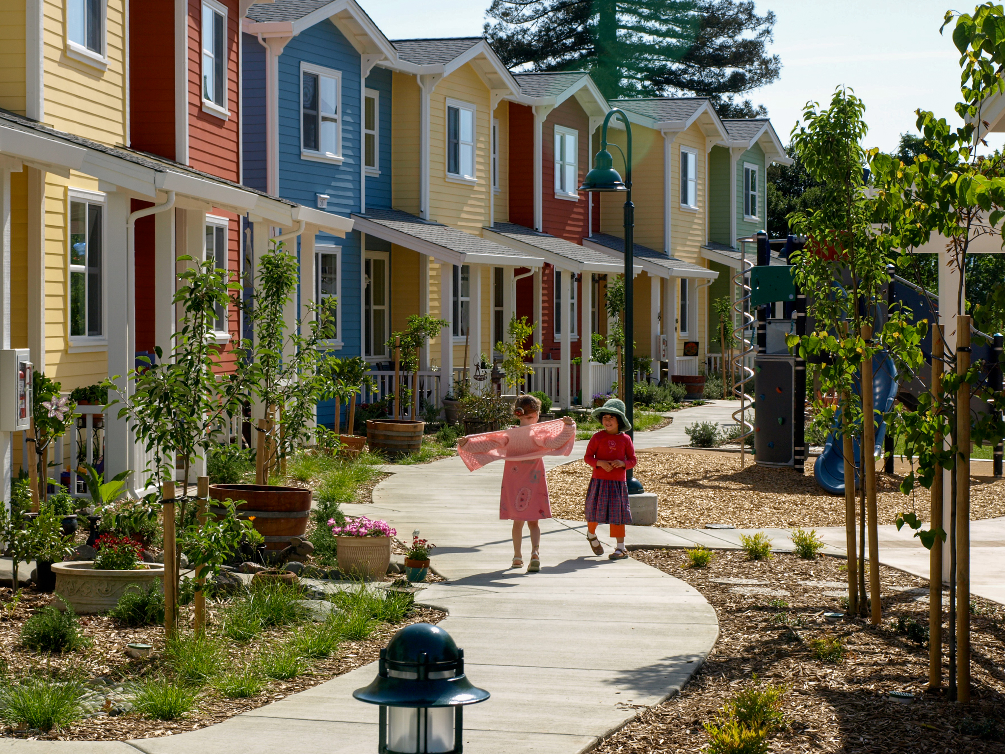 Children play on the walkway at Petaluma Avenue Homes in Petaluma, CA.