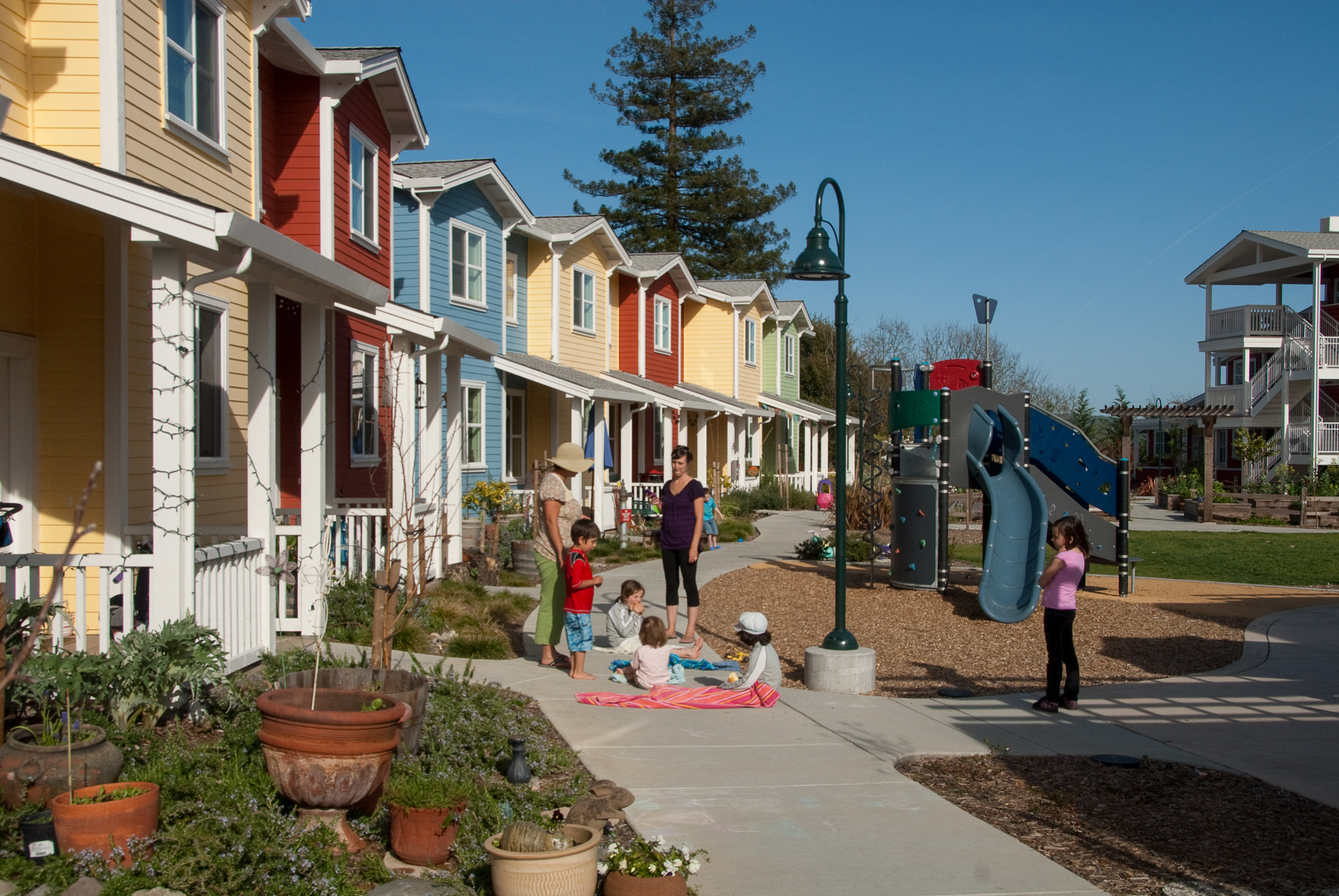 Residents gather outside at Petaluma Avenue Homes in Petaluma, CA.