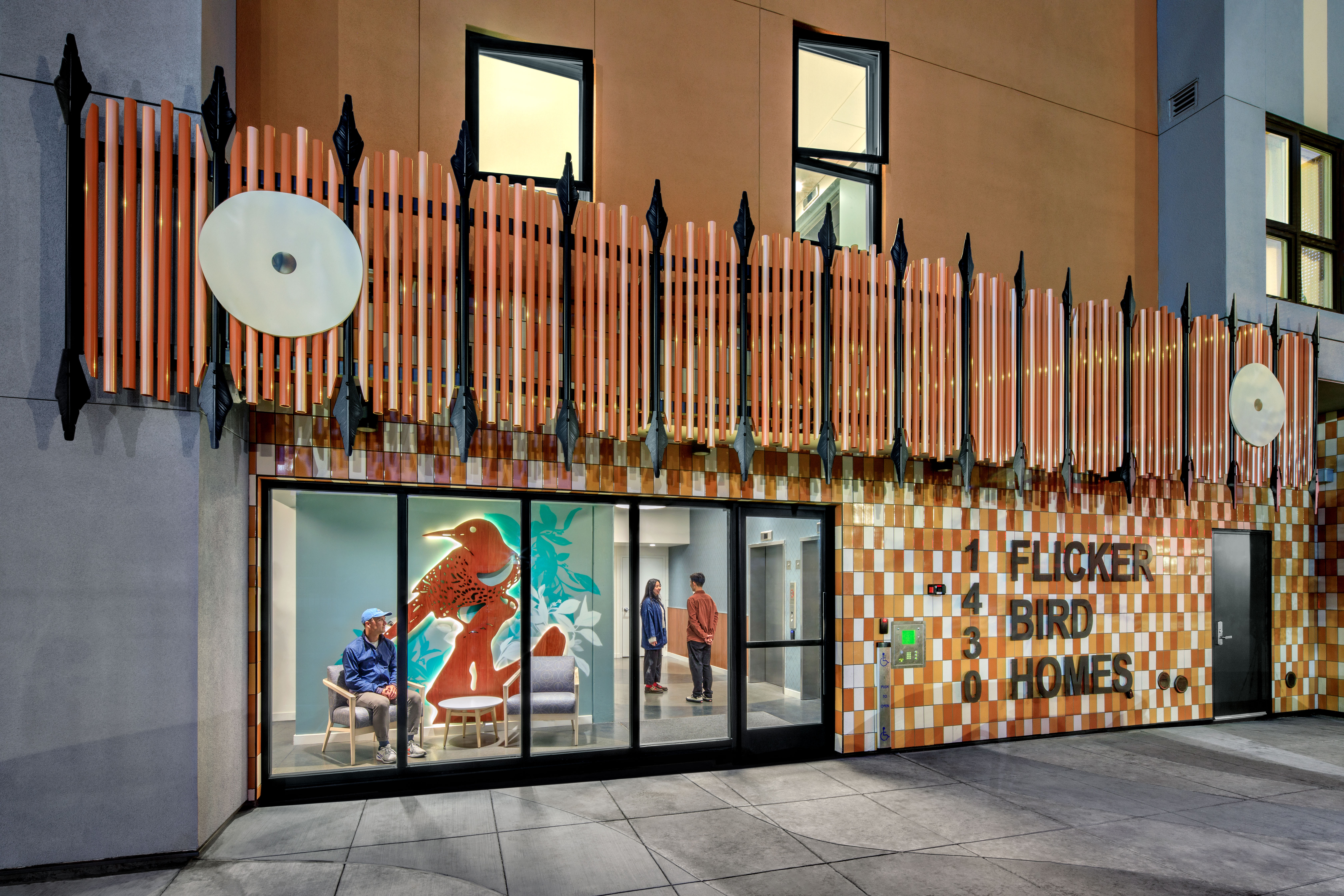 Main entrance signage and lobby view of Flicker Bird Homes and Native American Health Center in Oakland, CA
